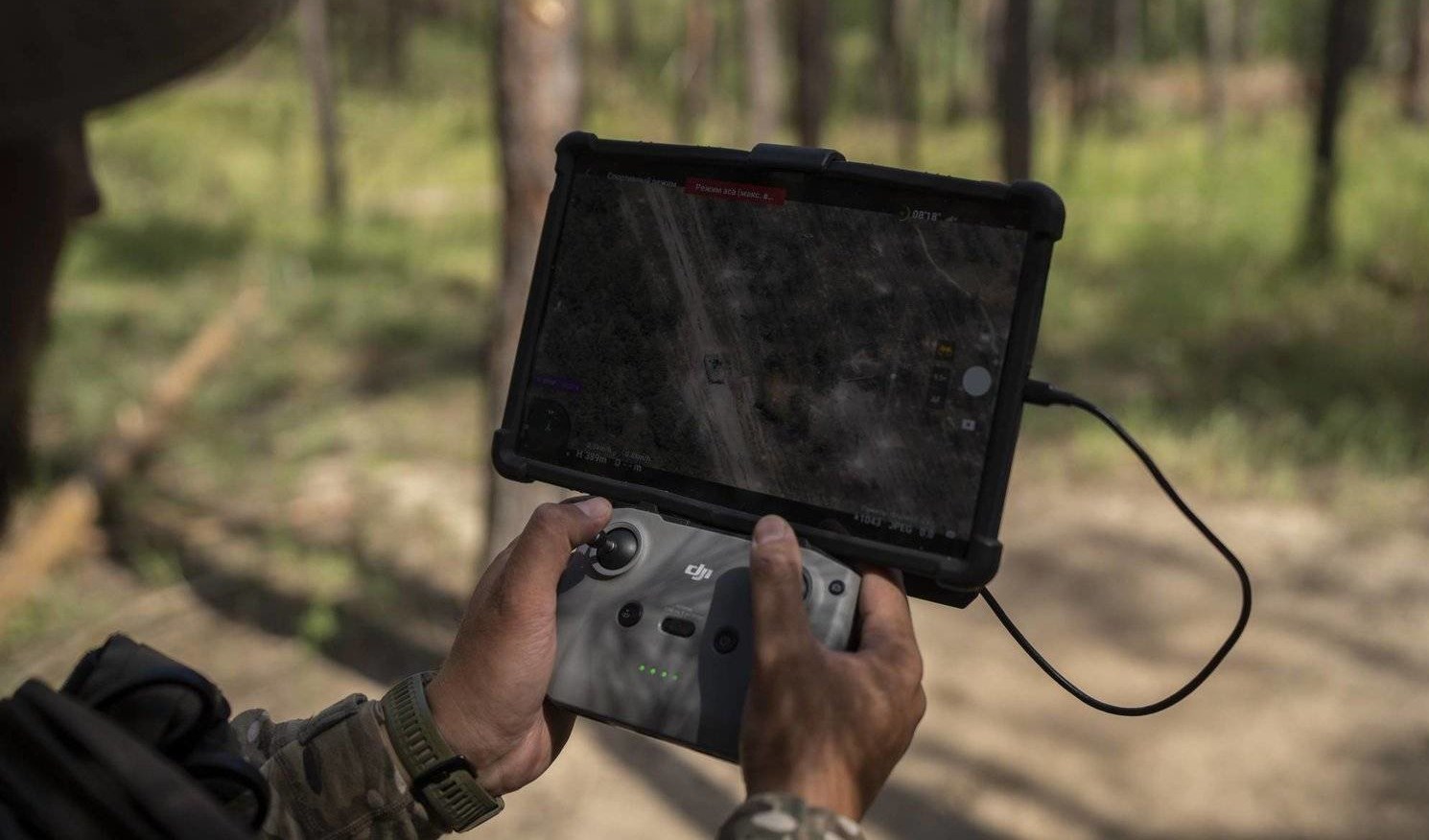 A Ukrainian soldier looks at a Russian tank on his screen while operating a drone to conduct a reconnaissance operation on the outskirts of Kreminna, Ukraine, Wednesday, August 16, 2023. (AP)