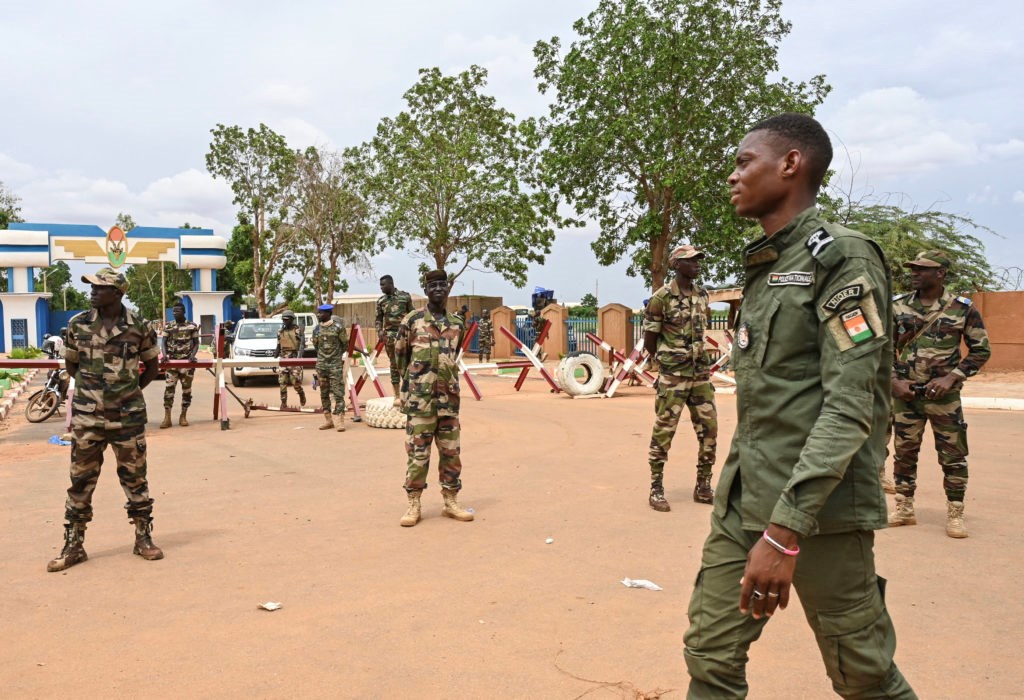 Nigerien soldiers stand guard as supporters of Niger's National Council for the Safeguard of the Homeland (CNSP) gather for a demonstration in Niamey on August 11, 2023 near a French airbase in Niger (AFP)