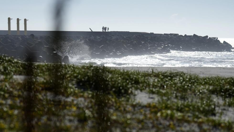 Journalists film the Fukushima Daiichi nuclear power plant from the nearby Ukedo fishing port in Namie town, northeastern Japan, Thursday, August 24, 2023 (AP)