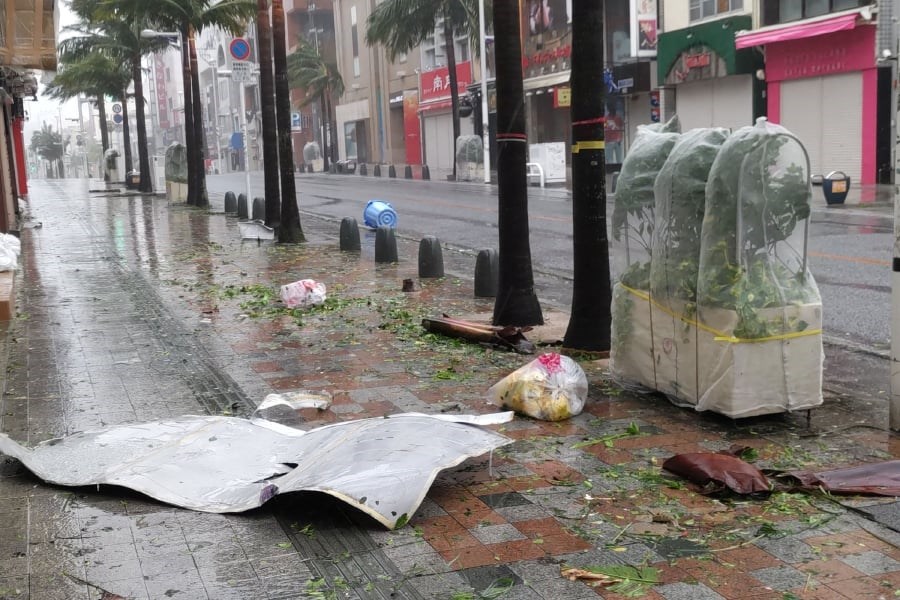 Scattered debris litters a downtown street as high winds brought by Typhoon Khanun hit the city of Naha, Okinawa prefecture. (AFP) /