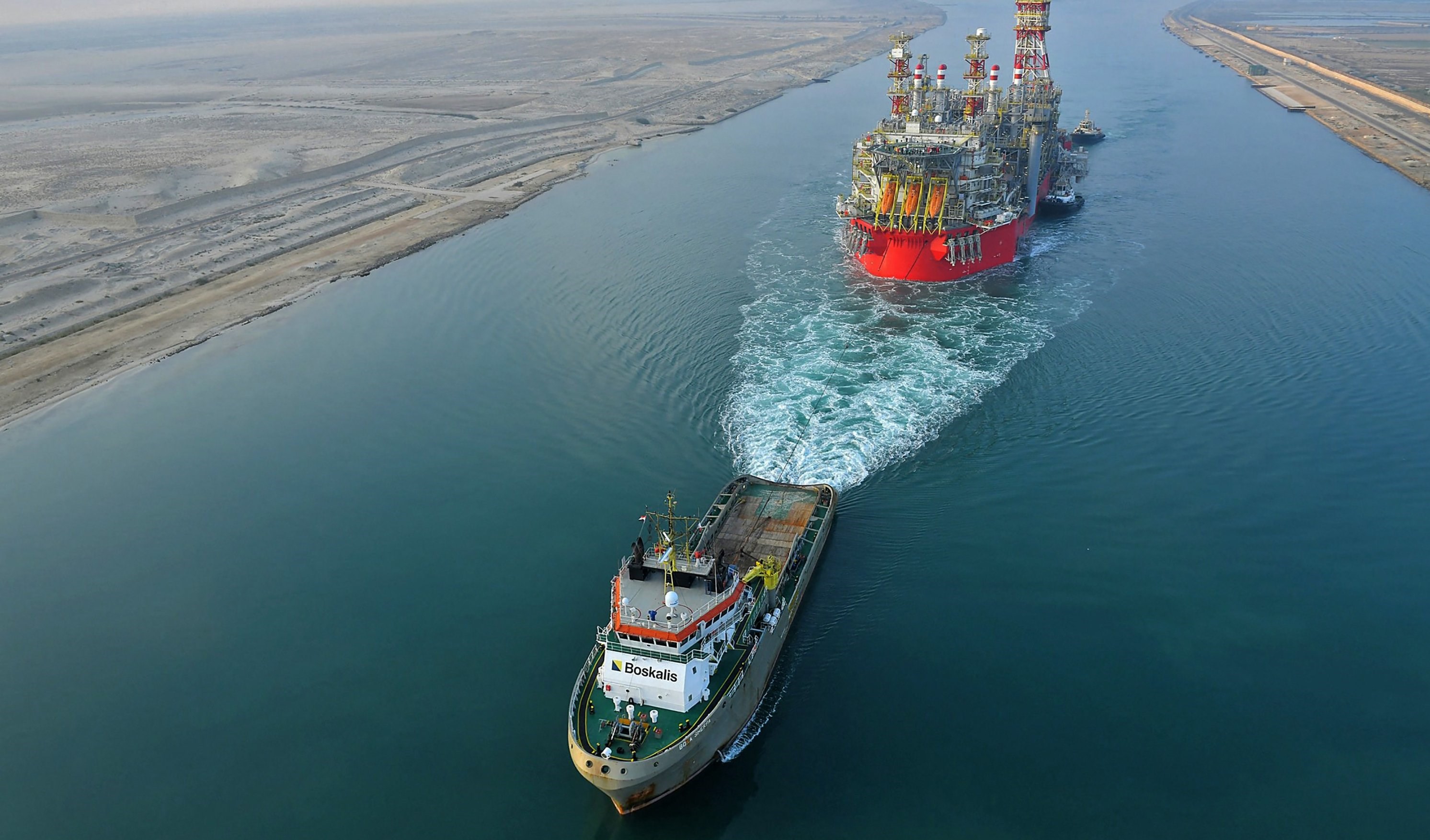 A tugboat pulling an Energean floating production storage and offloading (FPSO) ship along Egypt's Suez Canal, June 3, 2022. (AFP)