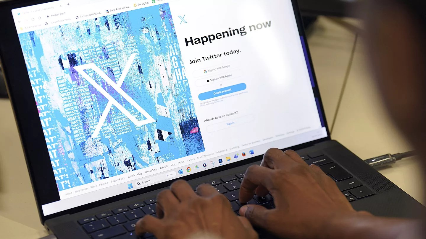 A person poses for a photo signing into the Twitter website which is now displaying the new logo in an undated photo (AP)