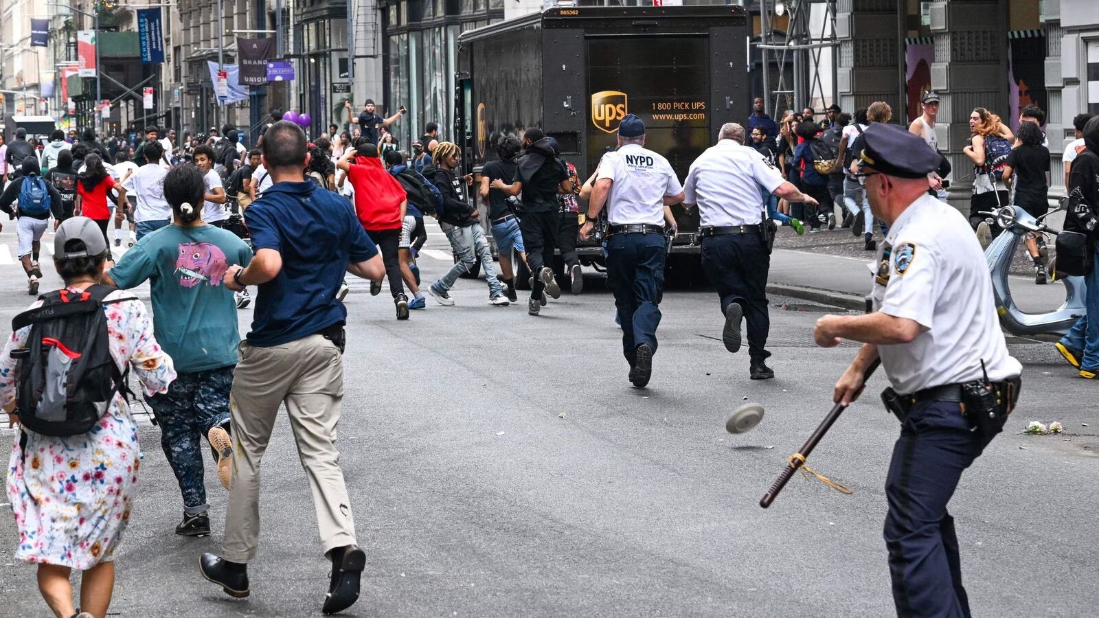 Plates and chairs are thrown near Chelsea during a 'giveaway' event in New York on August 4, 2023 (Photo: AFP)
