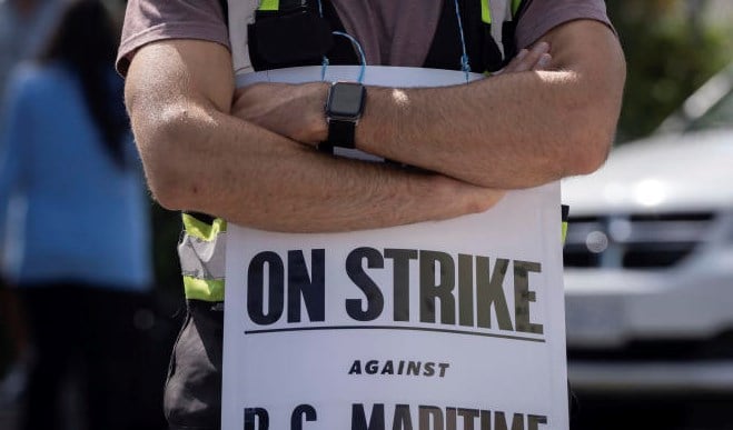 International Longshore and Warehouse Union workers picket outside of the BC Maritime Employers Association Dispatch Center after a 72 hour strike notice and no agreement made on the bargaining table in Vancouver, on Saturday, July 1, 2023. (AP)