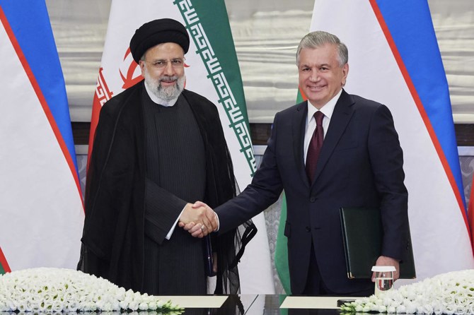 Uzbekistan President Shavkat Mirziyoyev and Iranian counterpart Ebrahim Raisi in September 2022 during their meeting in Samarkand, Uzbekistan (AP)