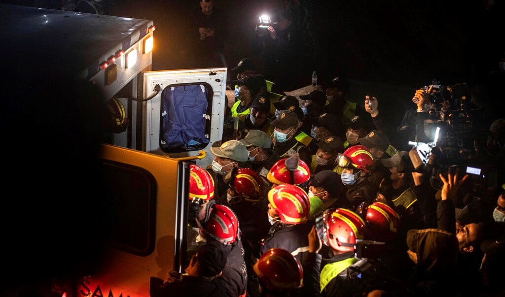 Rescue workers carry the body of 5-year-old Rayan and place it in an ambulance after it was retrieved from a hole in which he was stuck for several days, in the village of Ighran in Morocco's Chefchaouen province, Saturday, Feb. 5, 2022. (AP)