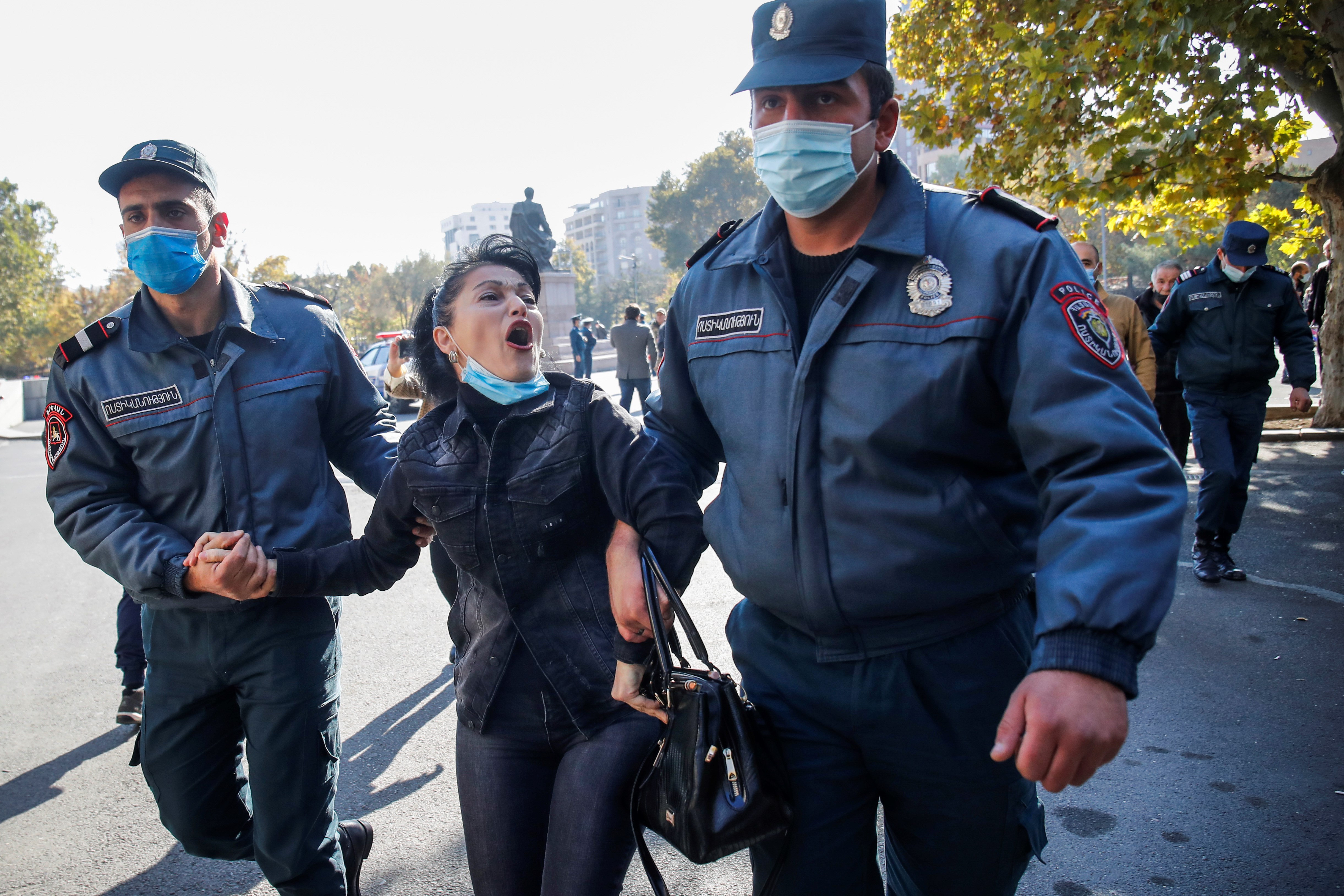 Police detain a woman during a protest against an agreement to halt fighting over the Nagorno-Karabakh region in Freedom Square in Yerevan, Armenia, Nov. 11, 2020 (AP)