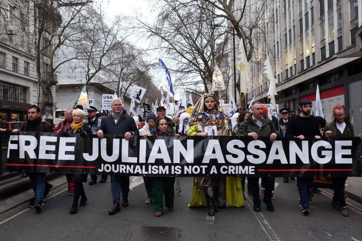 Supporters of WikiLeaks founder Julian Assange take part in a Night Carnival for Assange march in London, February on 2023. (AFP)