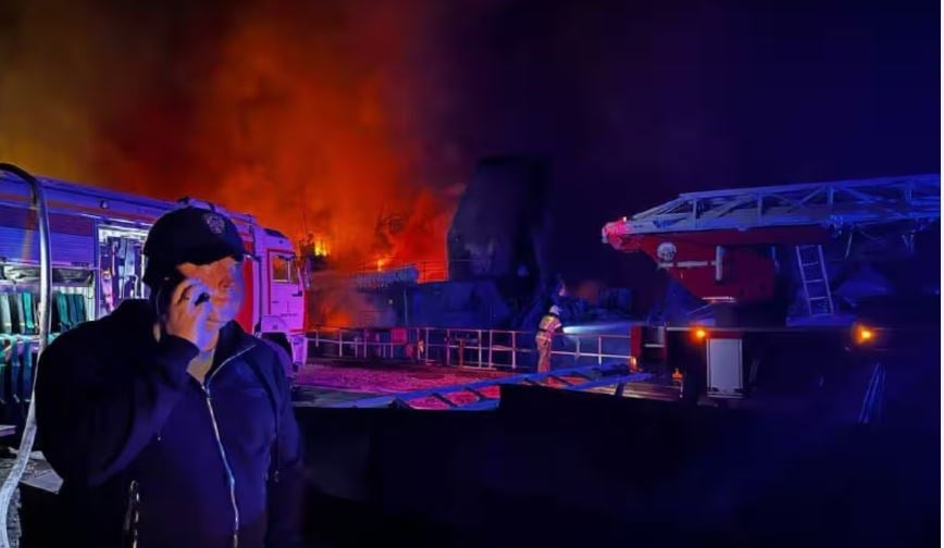 Mikhail Razvozhayev, governor of Sevastopol in Crimea, stands in front of a blaze at the shipyard. (Mikhail Razvozhayev/Telegram)