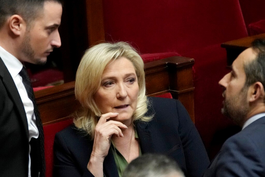 French far-right leader Marine Le Pen talks with National Rally group members at the National Assembly, Monday, Feb. 6, 2023 in Paris (AP Photo/Christophe Ena)