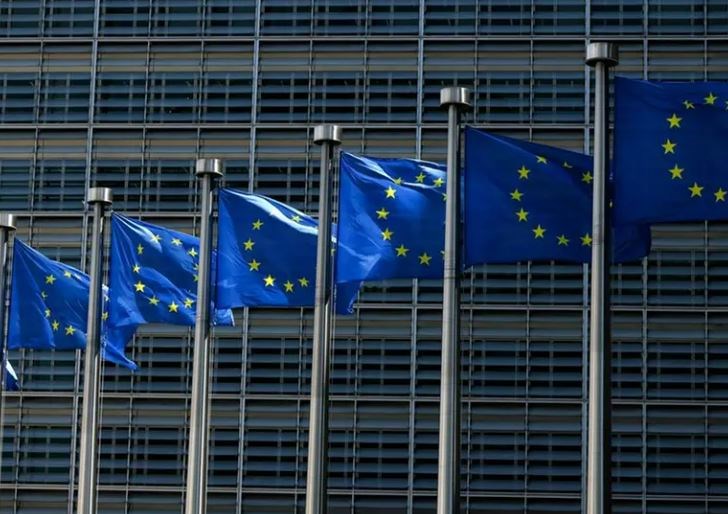 European Union flags fly outside the European Commission building in Brussel on June 16, 2022. (AFP)