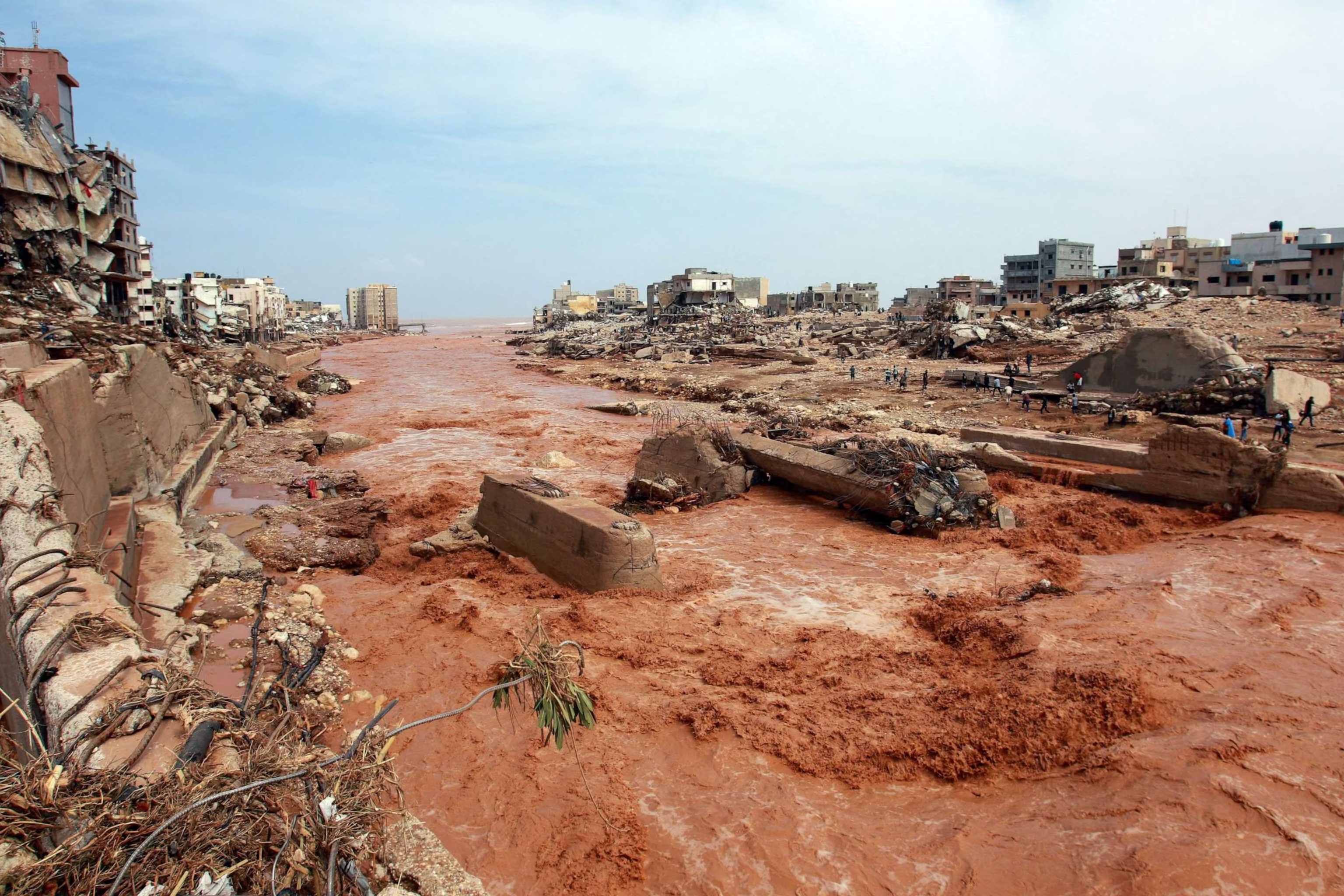 People look at the damage caused by floods in Derna, eastern Libya, on Sept. 11, 2023 (AFP)