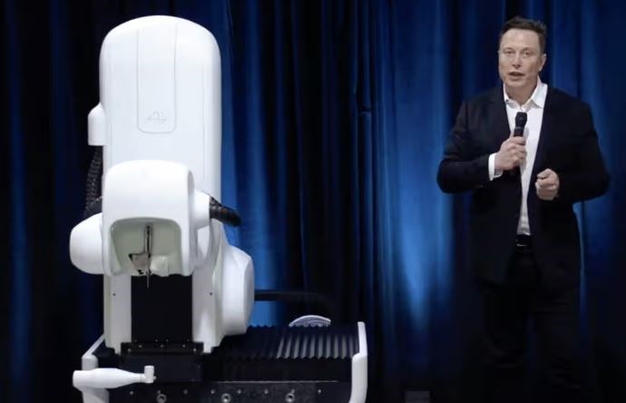 Elon Musk standing next to a surgical robot during his Neuralink presentation on 28 August 2020. (Neuralink/AFP via Getty Images)