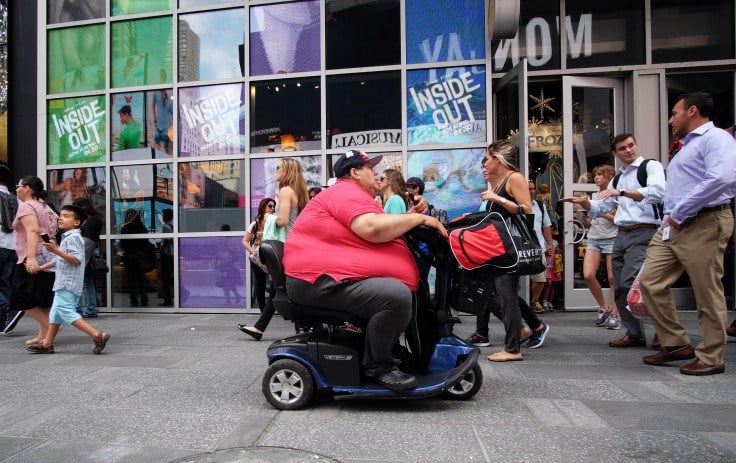 A man on an electric scooter makes his way with other pedestrians in New York on July 1, 2015 (AFP)