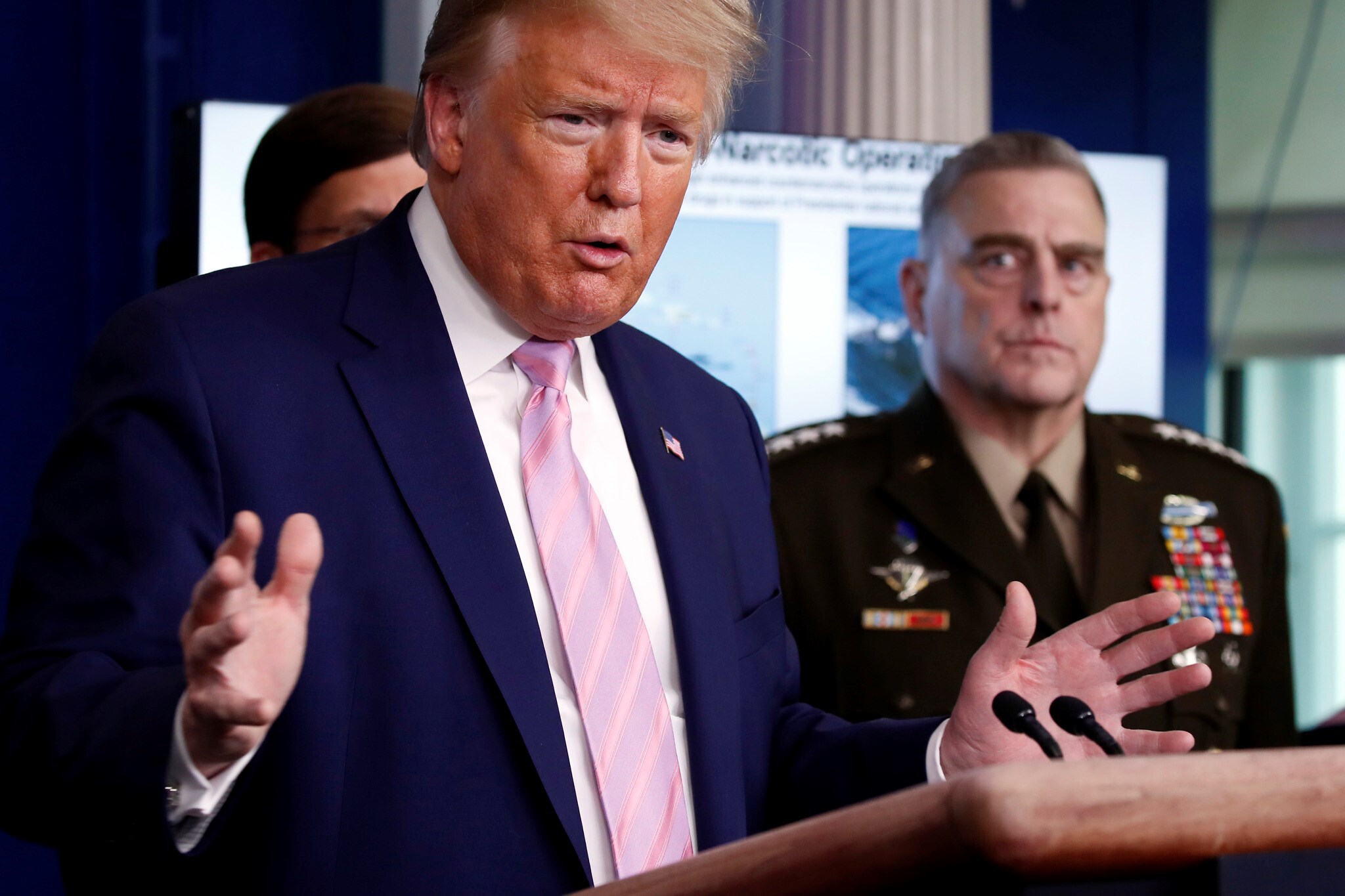 US President Donald Trump speaks in the James Brady Press Briefing Room of the White House, April 1, 2020, in Washington, as Chairman of the Joint Chiefs Gen. Mark Milley listens. (AP)