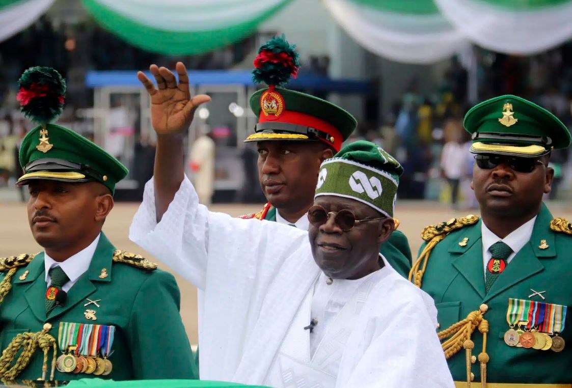 Nigeria's new President Bola Ahmed Tinubu, center, inspects honour guards after taking an oath of office at a ceremony in Abuja, Nigeria, Monday, May 29, 2023. (AP)