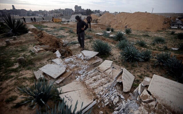 Palestinians inspect damaged graves following an Israeli raid over a cemetery in the Khan Younis refugee camp, southern Gaza Strip on Jan. 17, 2024. (AP)