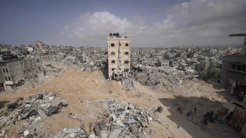 Palestinians stand amid the rubble of houses destroyed by Israeli bombardment in Khan Younis in the southern Gaza Strip on March 6, 2024. (AFP)