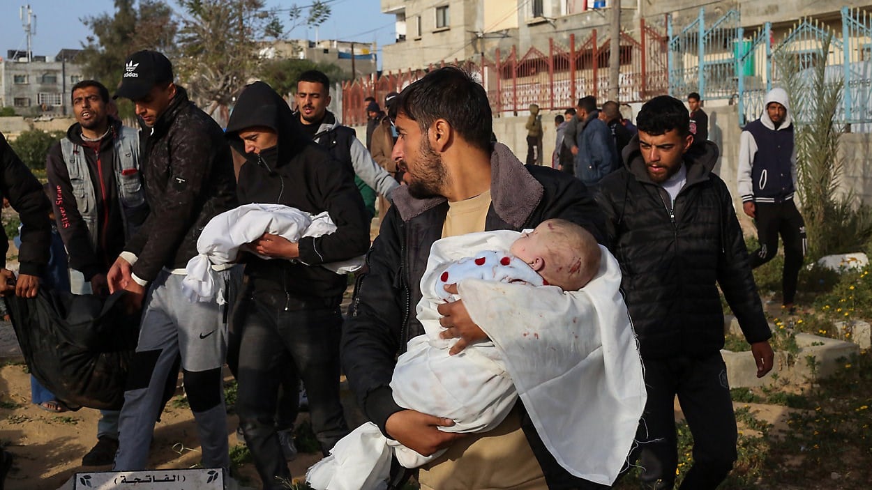 Family members carry the bodies of Palestinian twins, who were killed in an Israel strike on a residential house in Rafah, in the southern Gaza Strip, Sunday, March 3, 2024. (AP)