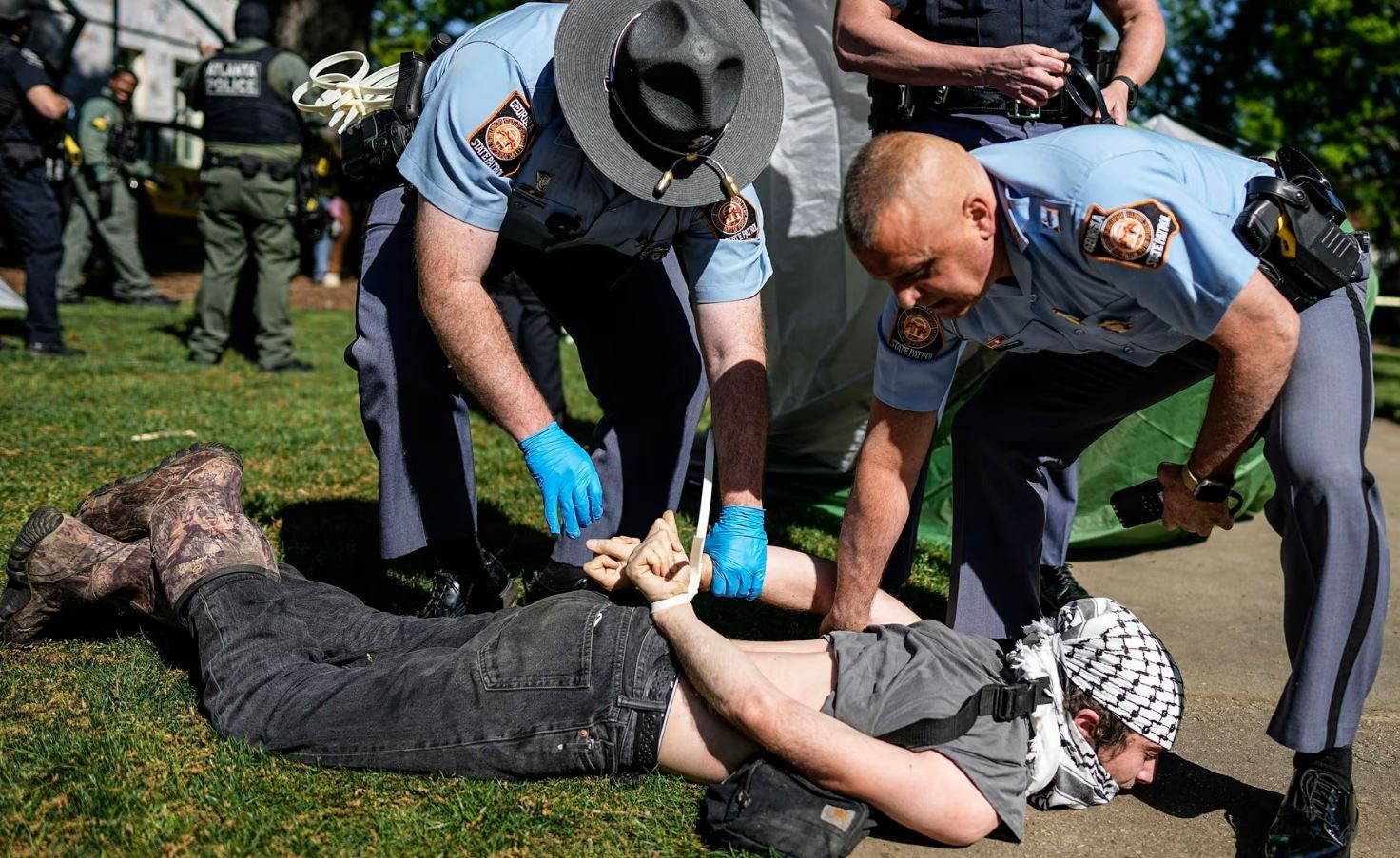 Officers detain a protester at Emory University on 26 April 2024. (AP)