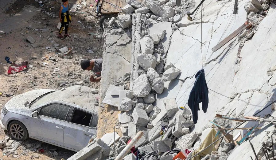 A Palestinian looking for survivors under residential building that was destroyed during Israeli bombardment at the Al-Daraj neighborhood in Gaza City on May 20. (AFP)